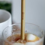 clear drinking glass with brown liquid